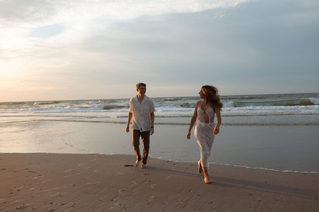 couple running on the beach for their engagement session